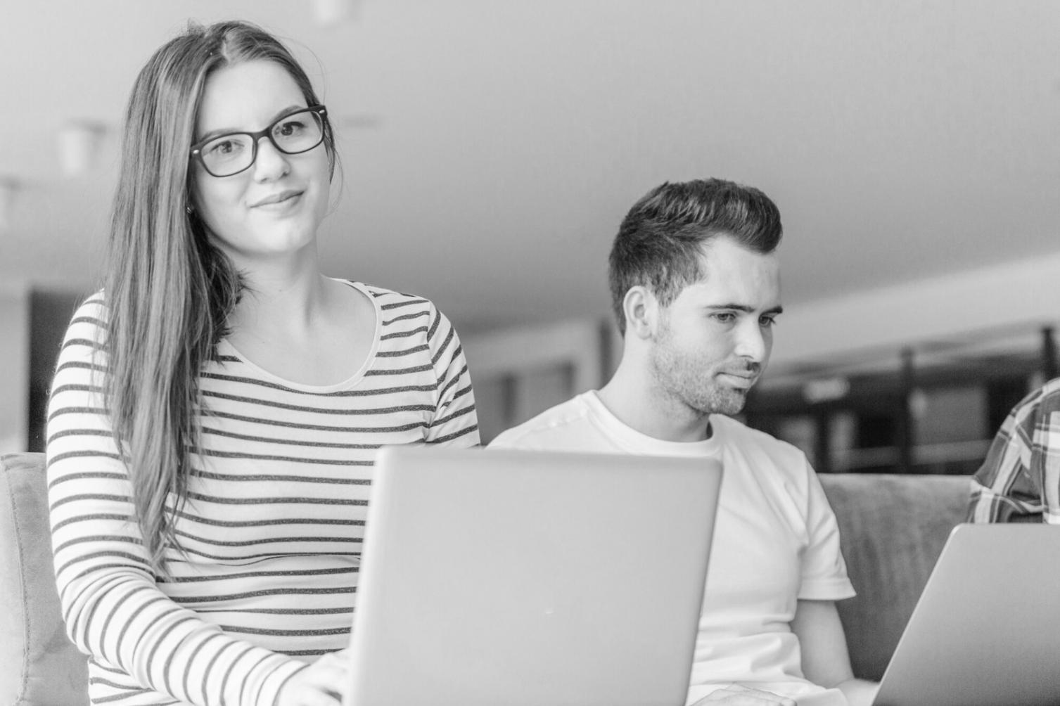 Student working on budget spreadsheet with calculator and notes